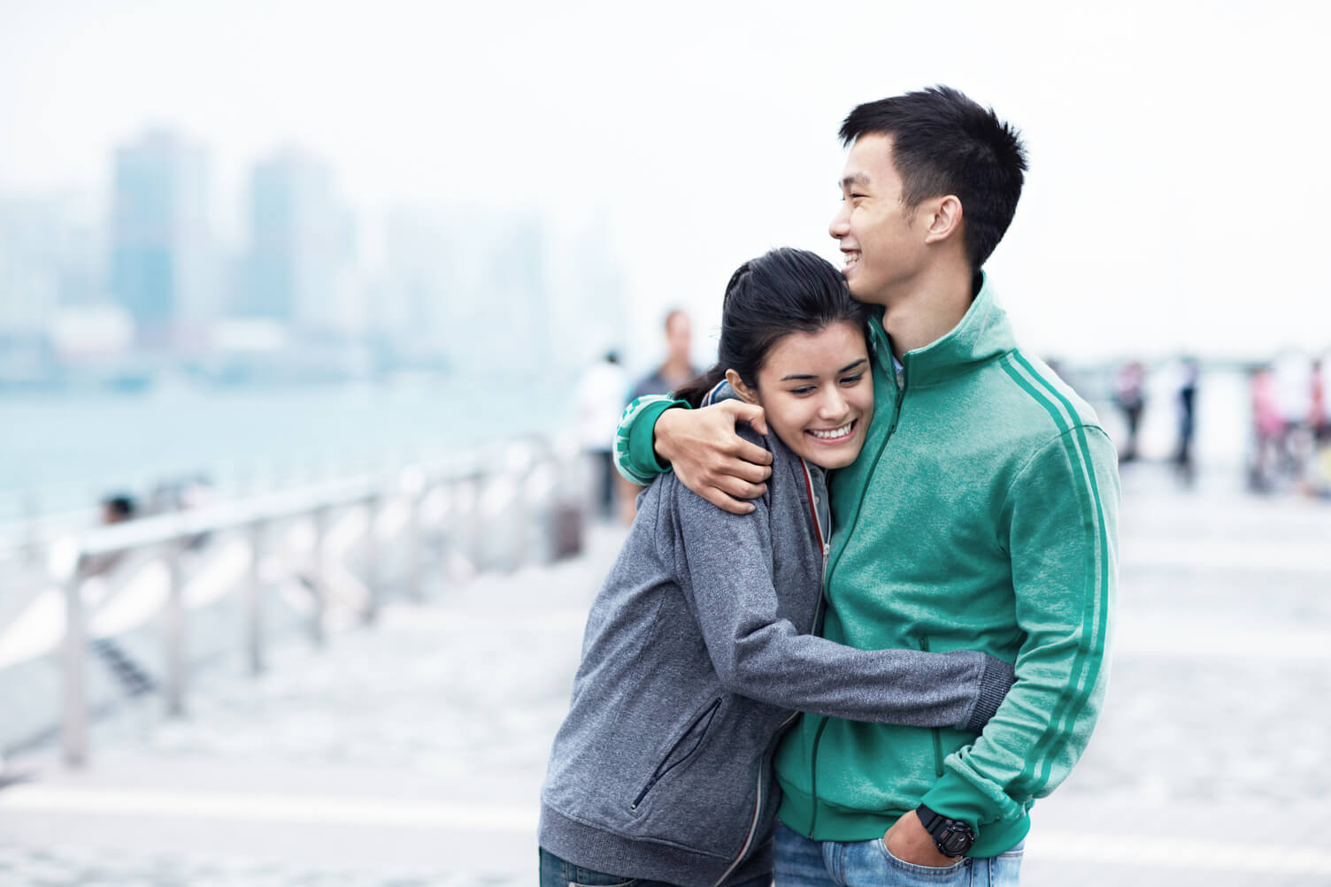 Young couple hugging and smiling.
