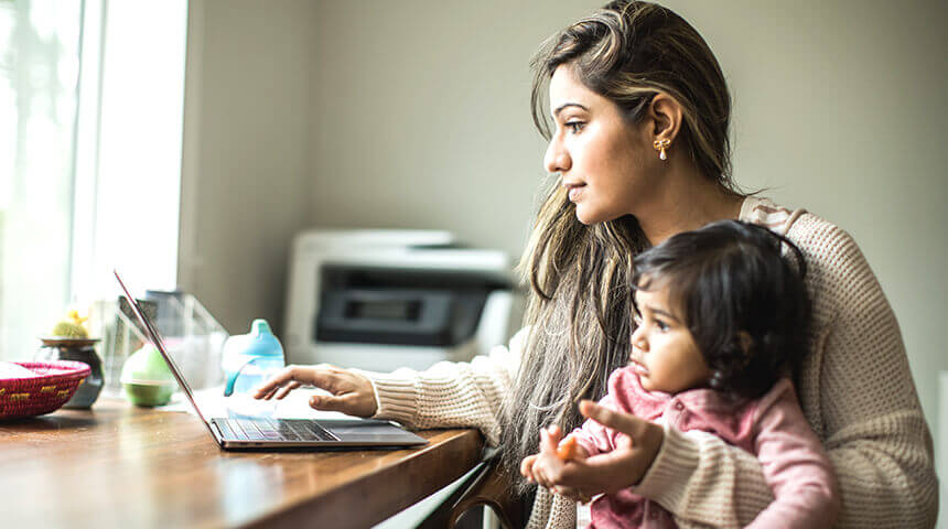 mother hold daughter laptop