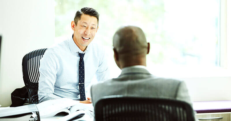 Smiling businessman in discussion with client
