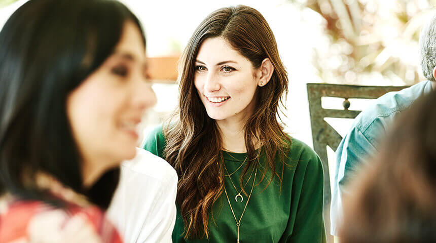 Smiling woman in discussion with family