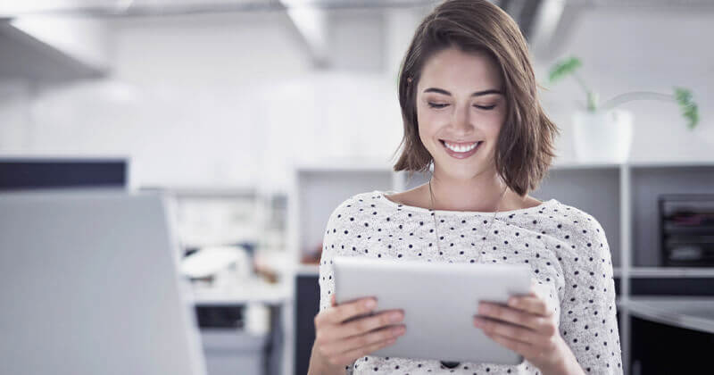 Young woman holding tablet smile